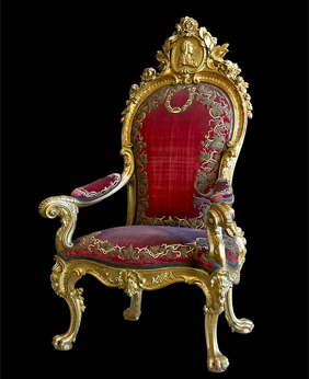 A throne with a gold frame and red upholstery