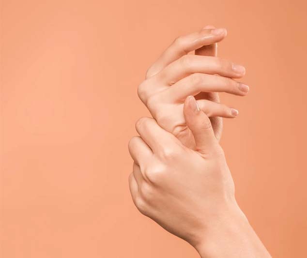 A pair of hands rubbing together against an orange background.