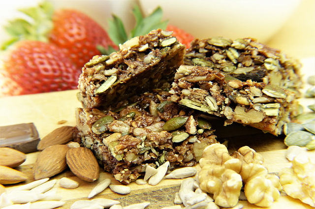 A pileup of dessert bars surrounded by some of its ingredients