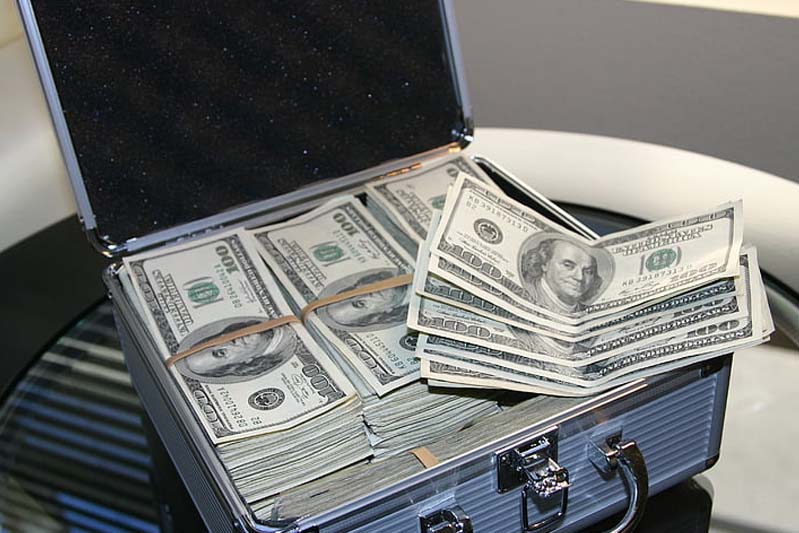 A briefcase filled with stacks of hundred dollar bills